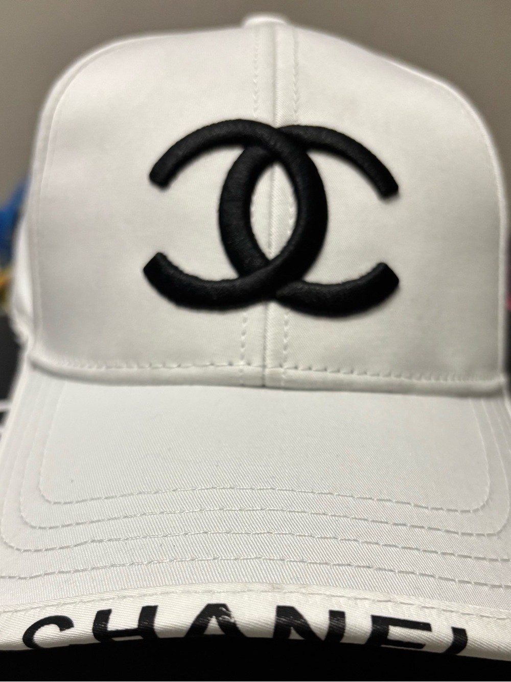 CHANEL White Cap with Black Interlocked CC